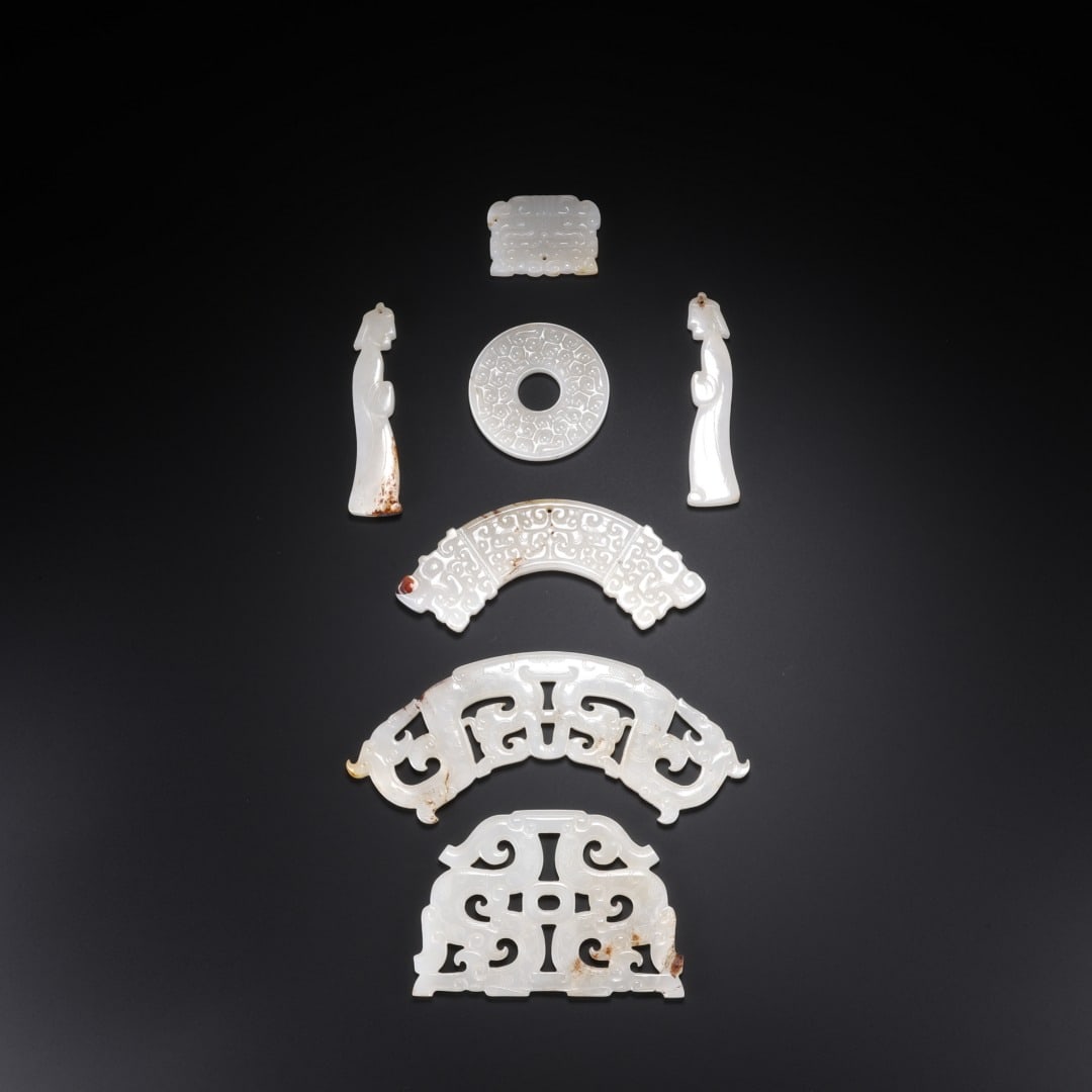 A SET OF HAN HETIAN JADE PENDANTS: Long: 7cm(2.76in), Width: 4.9cm(1.93in), Thick: 0.4cm(0.16in), Weight: 100g (0.220lb)Composed of multiple white jade components with mild texture and natural patina. The set includes jade bi disc, dou