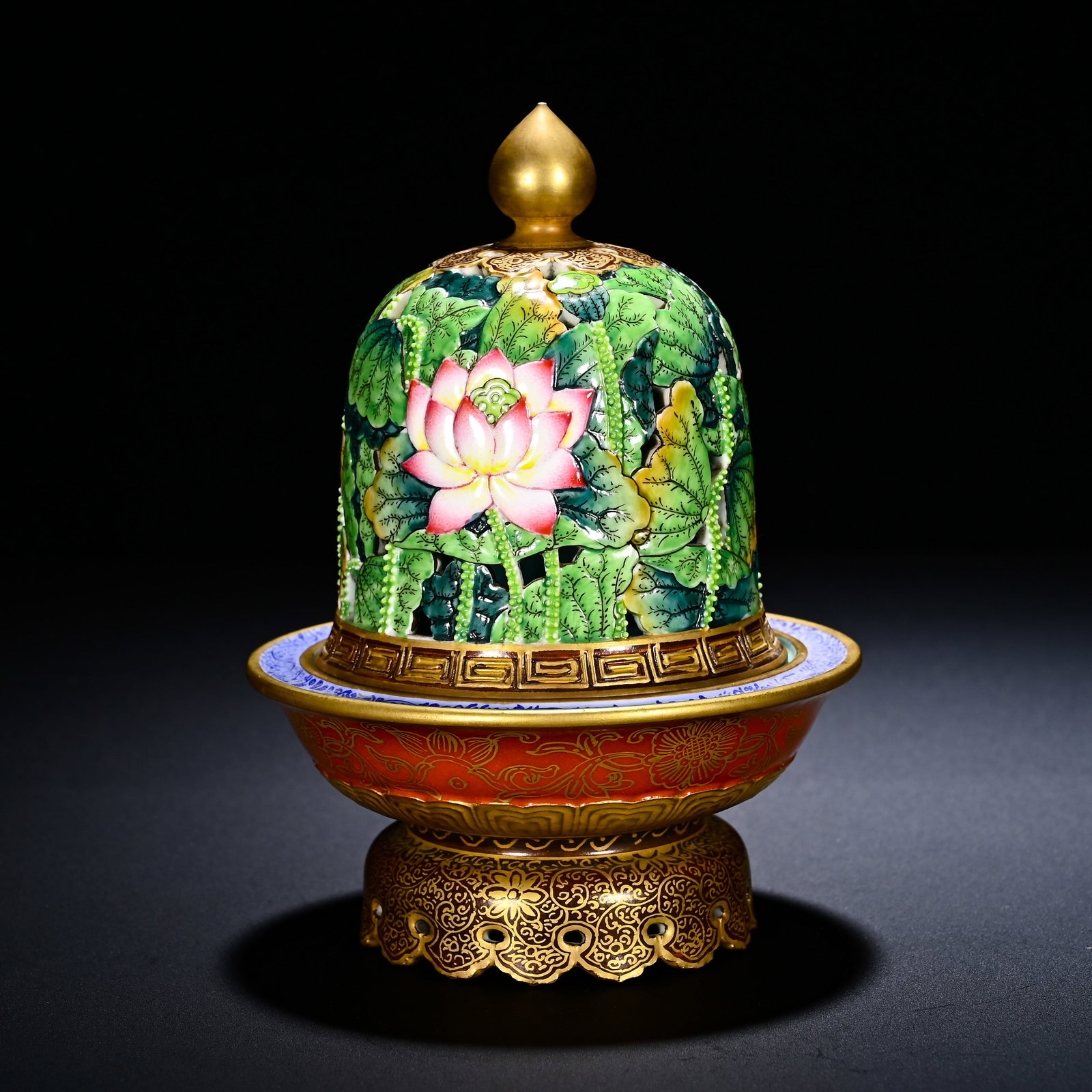 QING DYNASTY QIANLONG PASTEL HOLLOWED-OUT CARVINGS OF LOTUS PATTERNS GILDED INCENSE: Height: 12cm(4.72in), Diameter: 10cm(3.94in)This is a Qianlong?period famille?rose openwork?carved lotus?pattern gilded censer, composed of pierced cover, incense?bowl and foliated base. Gilded pearl?