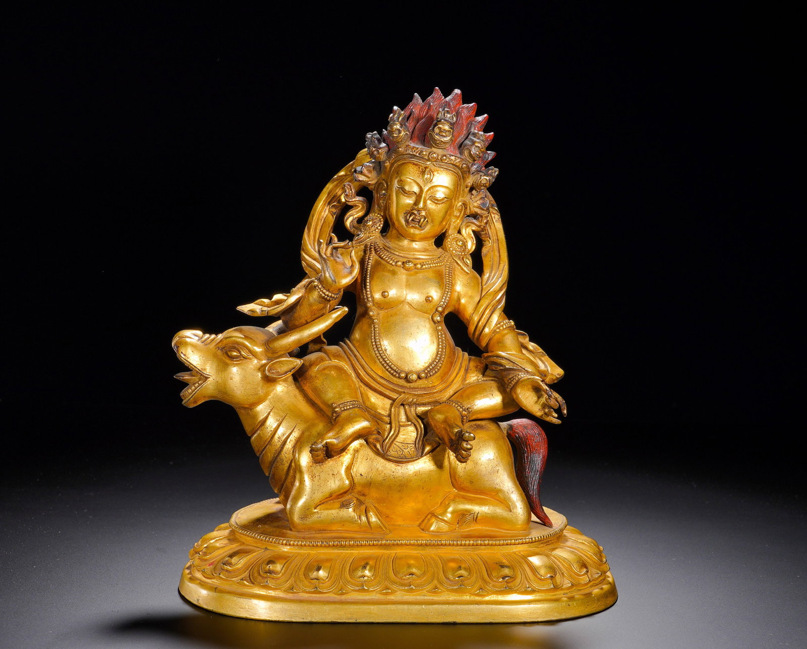 A GILDED BRONZE STATUE OF A FEMALE PROTECTOR RIDING A BULL FROM THE QING DYNASTY: Height: 23cm(9.06in), Width: 20cm(7.87in), Weight: 3340g (7.363lb)Belonging to the retinue of oath-bound protectors, this deity venerated for safeguarding Dharma, pacifying conflicts and dispelling ob