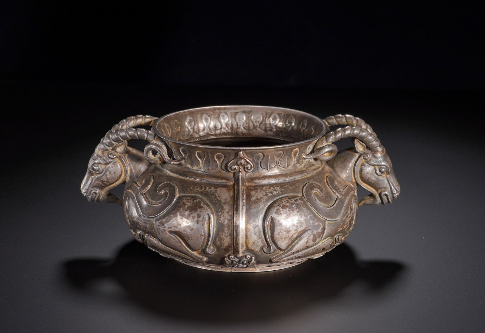 QING DYNASTY QIANLONG SILVER DOUBLE SHEEP EAR AUSPICIOUS SHEEP PATTERN FURNACE: Height: 8cm(3.15in), Width: 20cm(7.87in), Weight: 780g (1.720lb)Cast in solid silver. The vessel has a compressed bulbous body flanked by fully sculpted ram-head handles with spiraled horns. High-reli