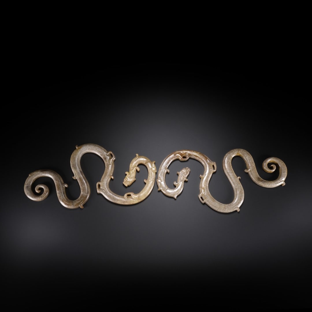 A PAIR OF S-SHAPED JADE DRAGONS FROM THE HAN DYNASTY (1 of 9)