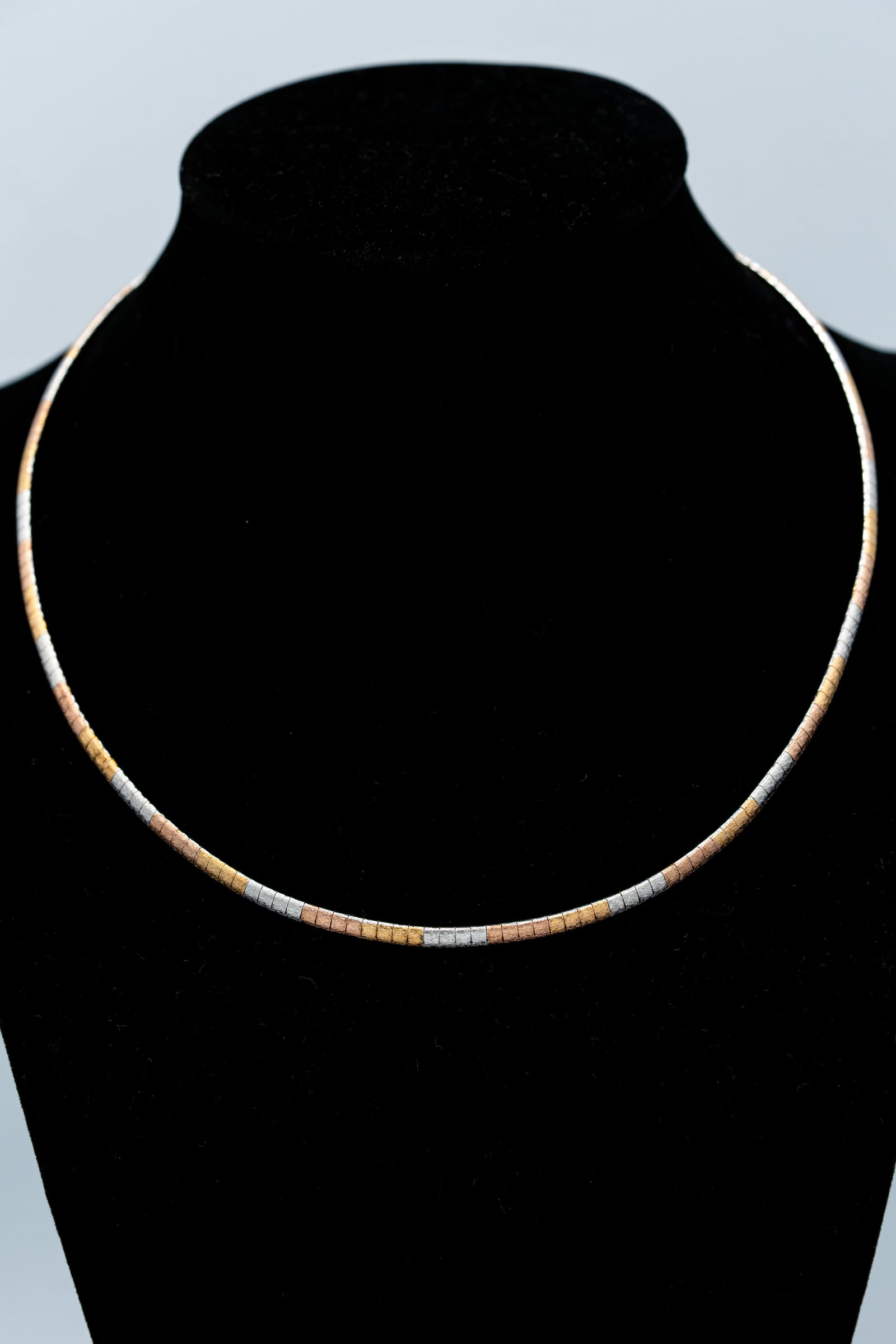 Tri-Color 925 Sterling Silver Flexible Omega Necklace, 16 Inches: A flexible omega-style necklace crafted in sterling silver with alternating yellow, rose and white metal-tone sections. The closely articulated links create a sleek, fluid collar profile with a subtle