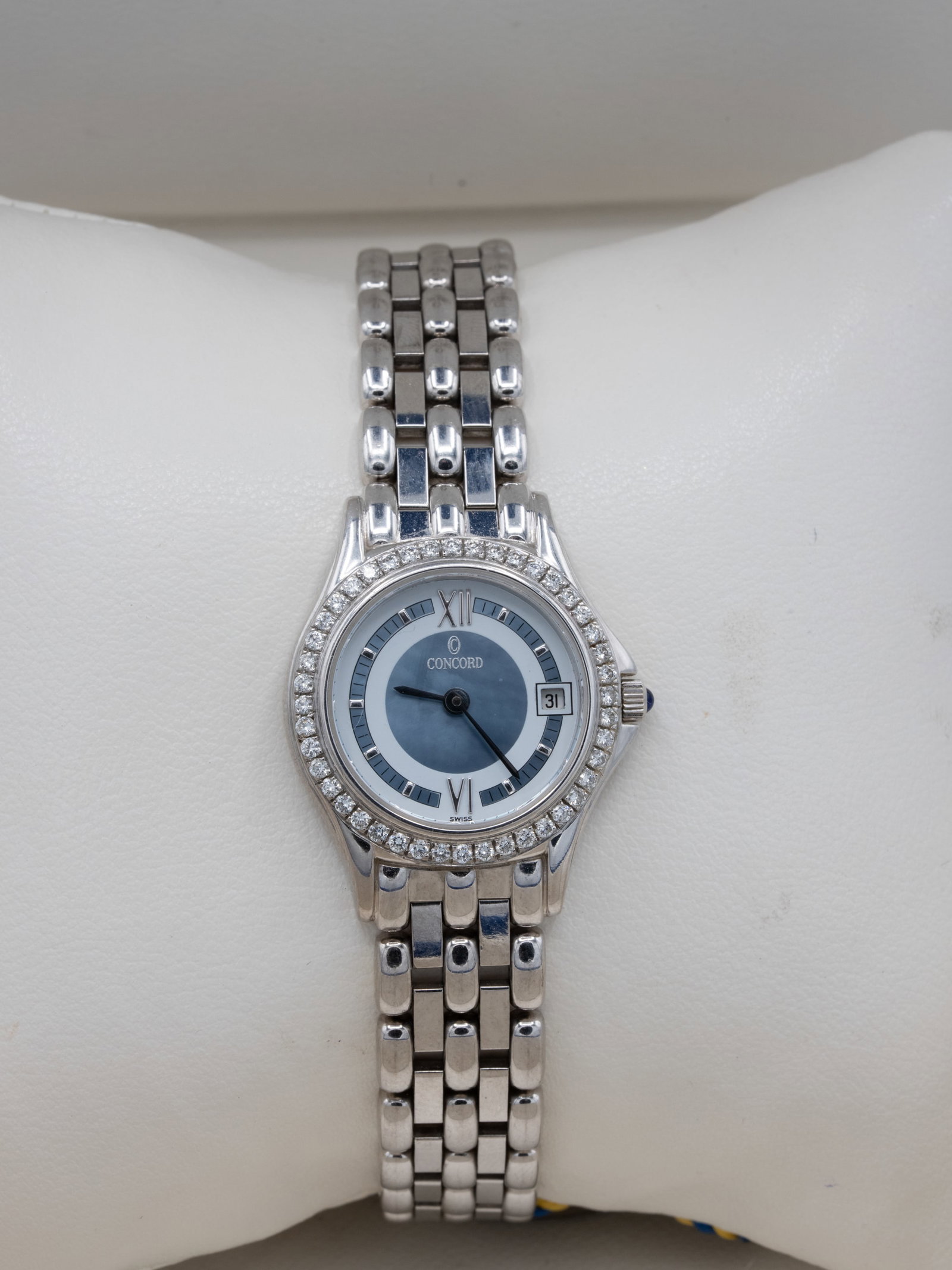 Concord 18K White Gold Diamond Ladies’ Quartz Watch, Ref. 61-36-265, Box: Concord Swiss ladies’ wristwatch, reference 61-36-265, crafted in 18K white gold and weighing approximately 64.0 grams gross. The round case features a diamond-set bezel surrounding a blue guilloch�