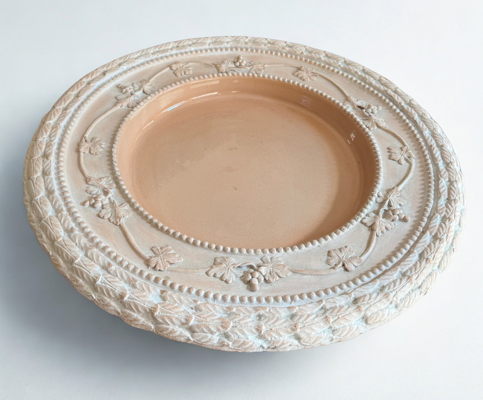 Italian Terracotta Footed Serving Platter: Terracotta Footed Serving Platter, Made in Italy, signed. Relief-molded grapevine and patterned border, featuring a white or light-colored wash over the natural terracotta clay. Dimensions: Diameter: 