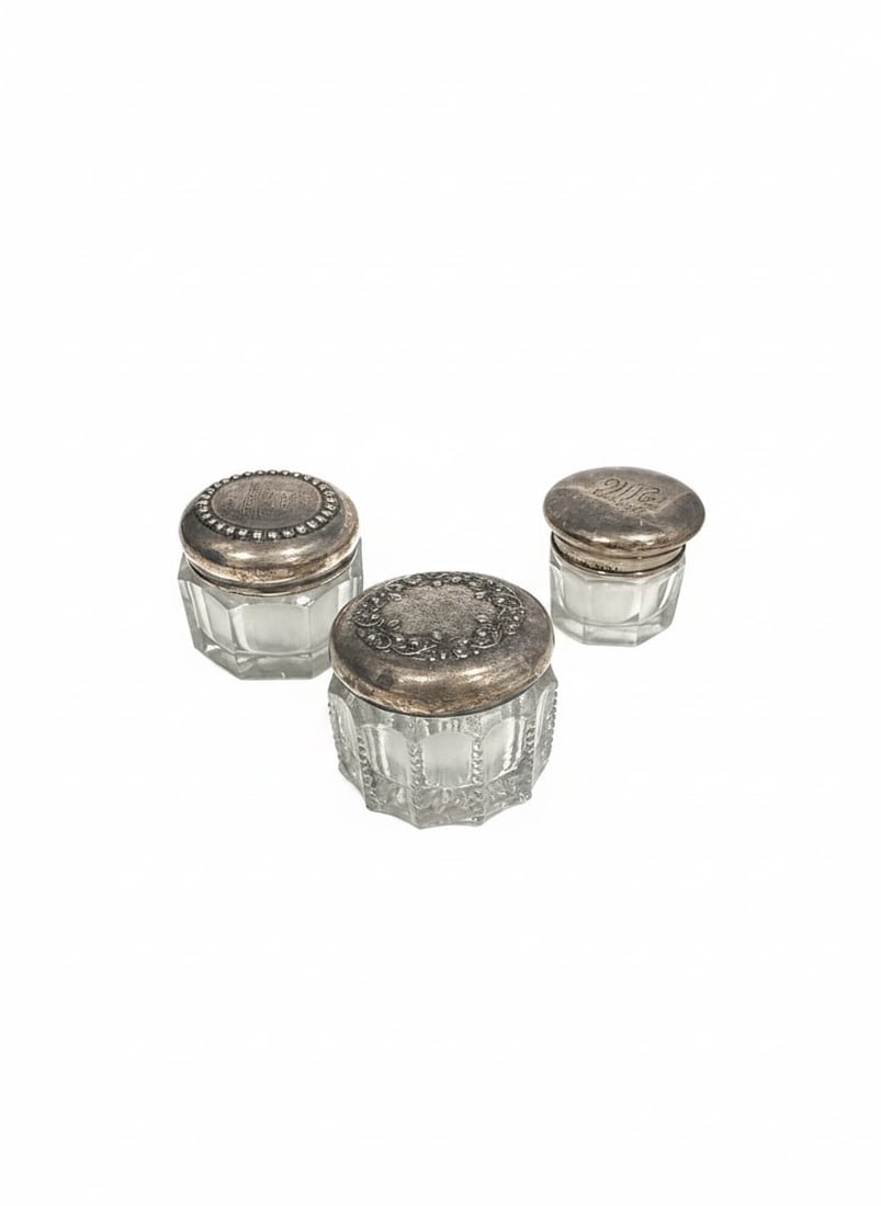 3 Vanity Jars with Sterling Silver Lids: Three vintage glass vanity jars with sterling silver lids, each measuring approximately 1.5 x 1.5 x 1.375 in. Total sterling lid weight: 14.8 grams; glass is not included in the sterling weight.