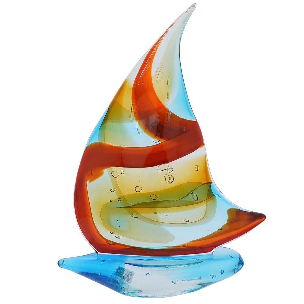 Murano Glass Large Sailboat - Sky Blue and Red: Hear the siren call of the faraway seas when you look at this beautifully handcrafted Murano Glass sailboat with its fluttering headsail in tender blue and rich red colors. This exquisite Venetian boa