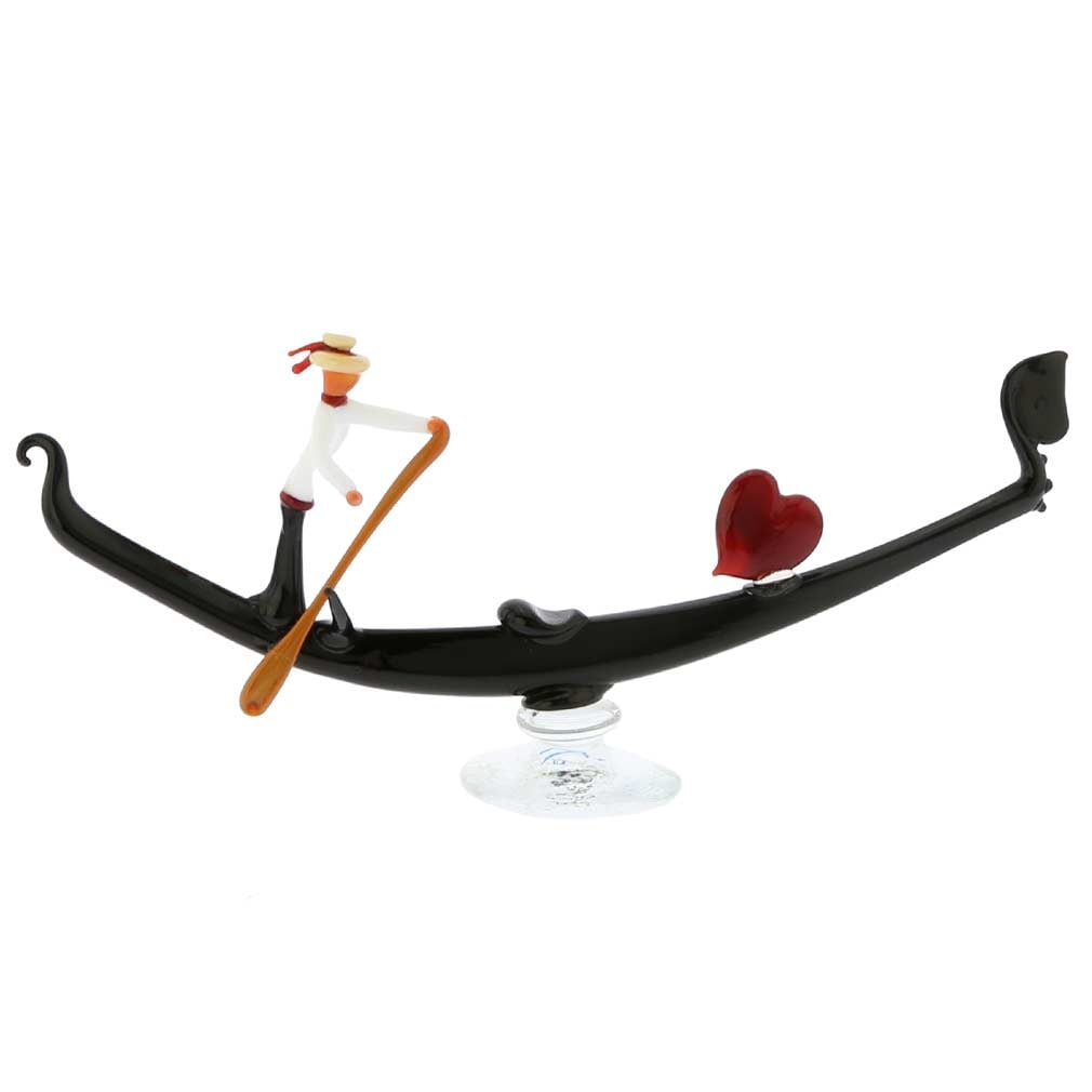 Murano Glass Venetian Black Gondola with Gondolier and Heart: Venice has been known for ages as the city of romance and love, with its timeless symbol, the gondola, epitomizing the enchantment and mystery of La Serenissima. This slender black gondola was designe