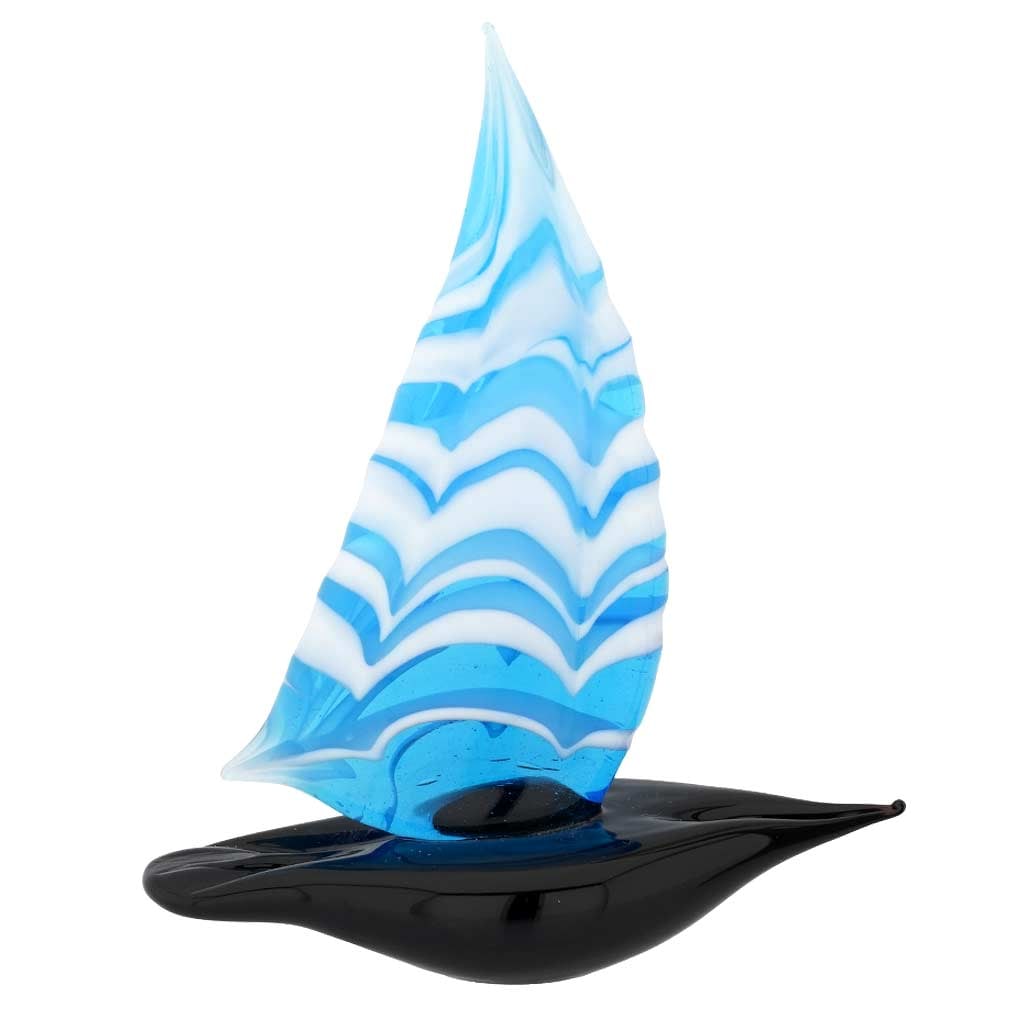 Murano Glass Small Sailboat - Aqua Blue: Feel the salty air, imagine the far-away lands, and get immersed in the ever-changing beauty of the sea when you look at this exquisite handcrafted Murano Glass sailboat figurine. The graceful boat pr