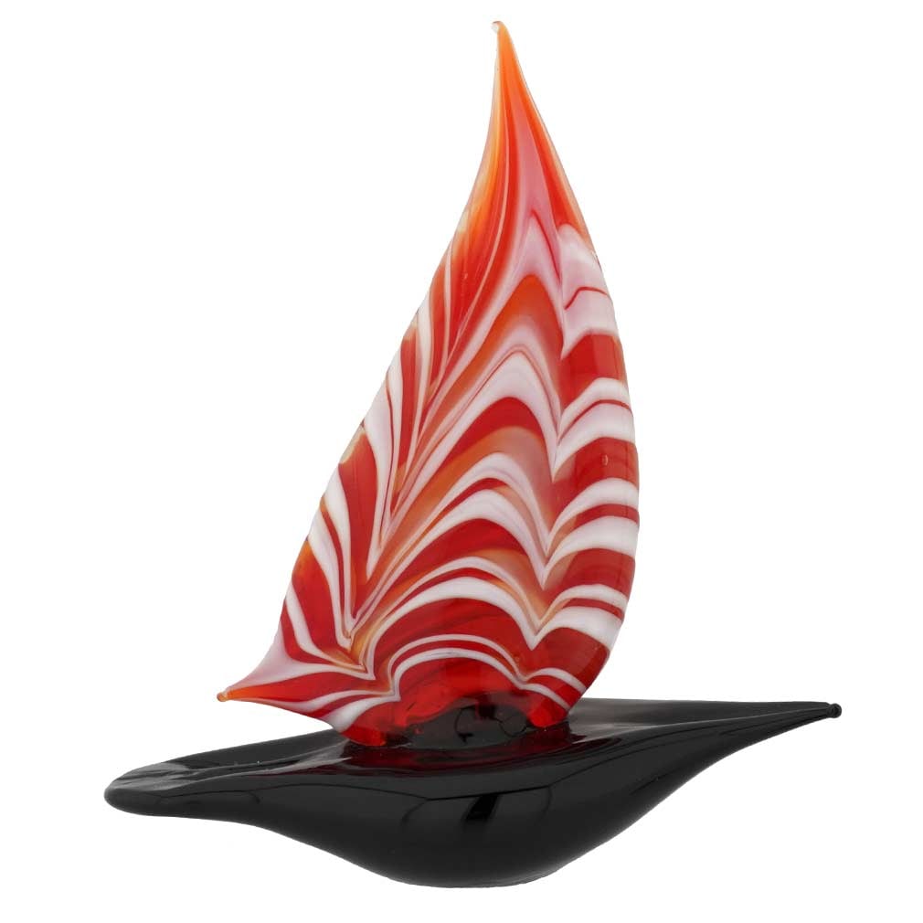 Murano Glass Small Sailboat - Red: Feel the salty air, imagine the far-away lands, and get immersed in the ever-changing beauty of the sea when you look at this exquisite handcrafted Murano Glass sailboat figurine. The graceful boat pr