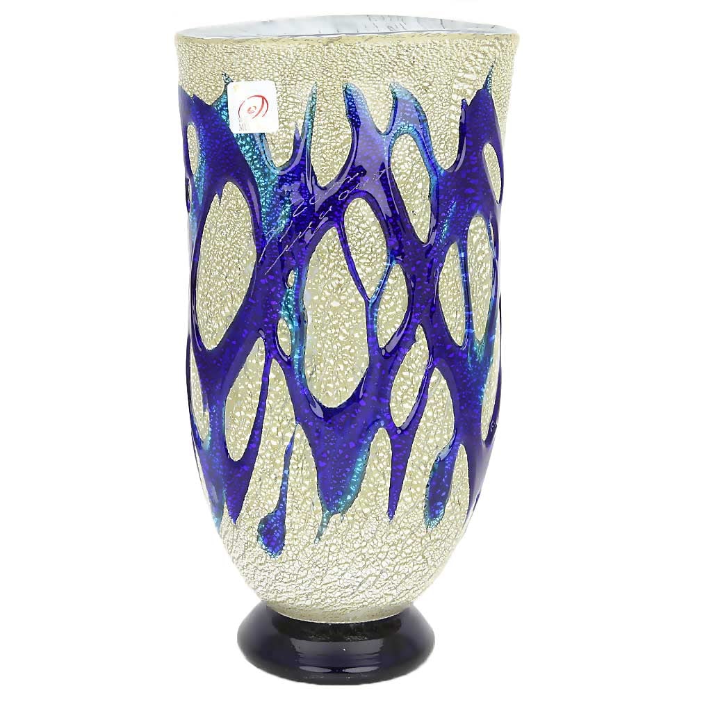 Murano Glass Silver Vase - Blue Web: This beautiful silver glass vase, born in the fire of world-famous Murano Glass furnaces, features elegant contemporary form and gorgeous colors. An amazing web of rich blue, almost liquid, glass wrap