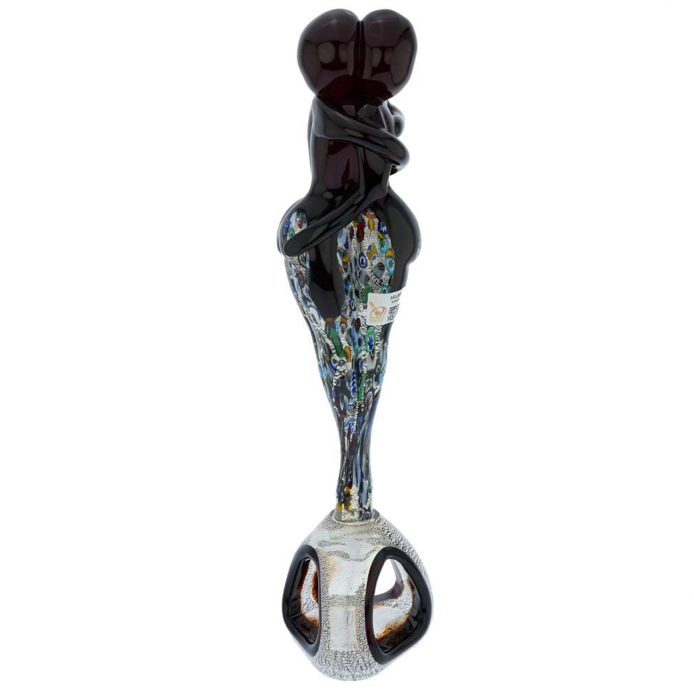 Murano Glass Silver Red Millefiori Lovers On A Base: A symbol of Venetian romance and Italian passion, this figure of Murano Glass Millefiori Lovers in a tight embrace is enchanting and stunning. The artful design is complemented by the perfect craftsma