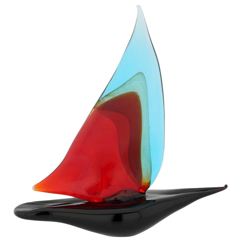 Murano Glass Small Sailboat - Aqua Red: Feel the salty air, imagine the far-away lands, and get immersed in the ever-changing beauty of the sea when you look at this exquisite handcrafted Murano Glass sailboat figurine. The graceful boat pr