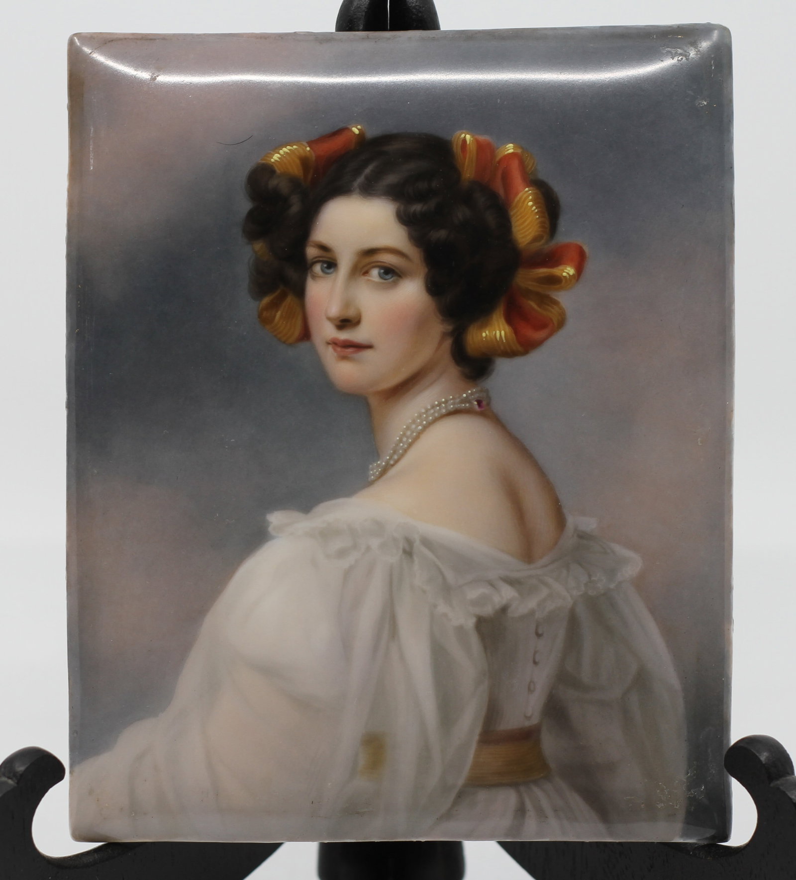 Antique Hand-Painted Porcelain Portrait Plaque of Elegant Young Lady, Late 19th Century: A finely executed antique hand-painted porcelain plaque depicting a beautiful young woman shown in three-quarter profile, wearing an elegant white dress, double-strand pearl necklace with jeweled clas