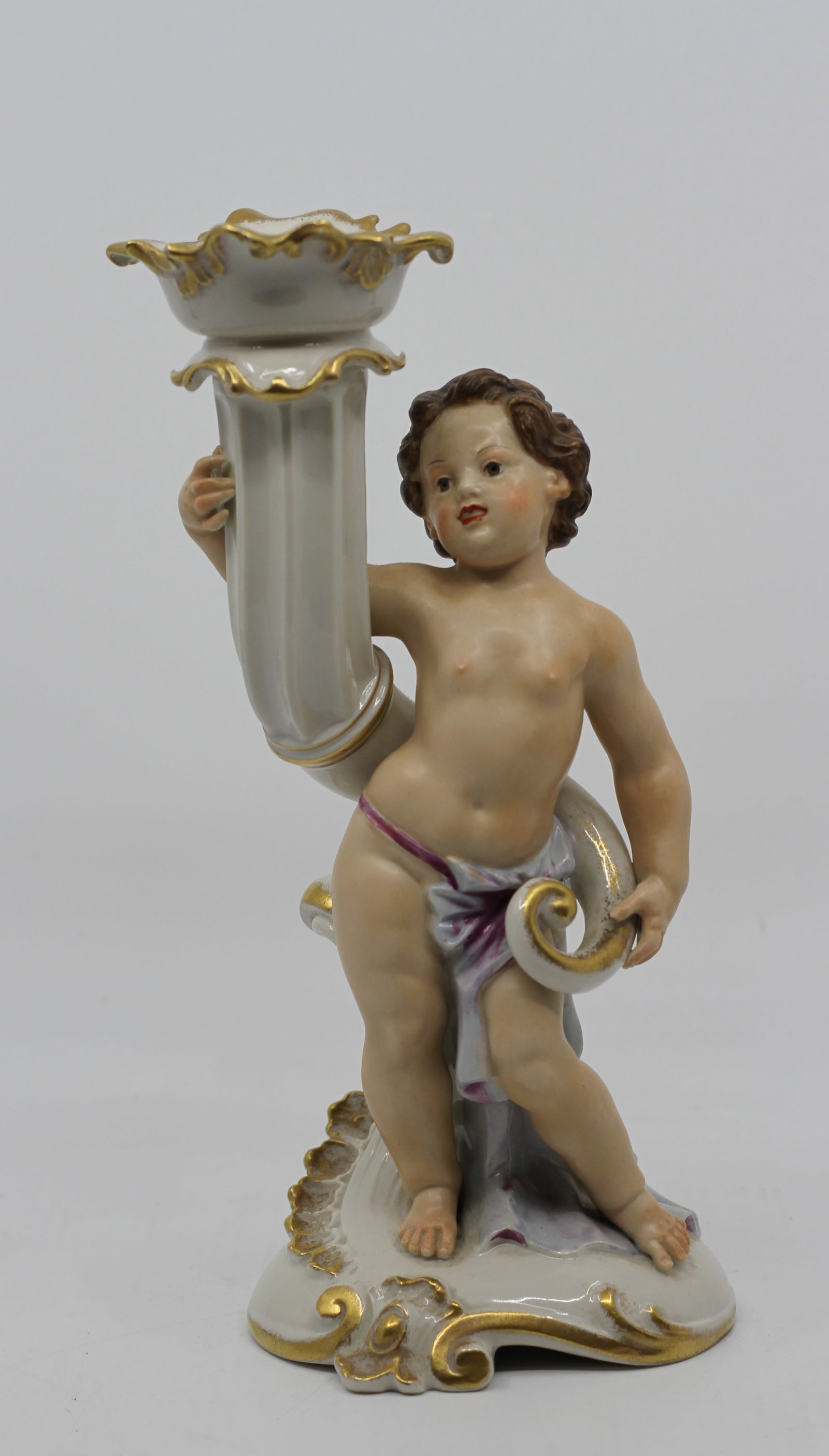 Winterling Bavaria Royal Heidelberg Cherub Putto Porcelain Candlestick Figure: Elegant Royal Heidelberg by Winterling Bavaria porcelain figural candlestick featuring a beautifully modeled cherub (putto) standing beside an ornate scrolling candlestick support with a richly molded