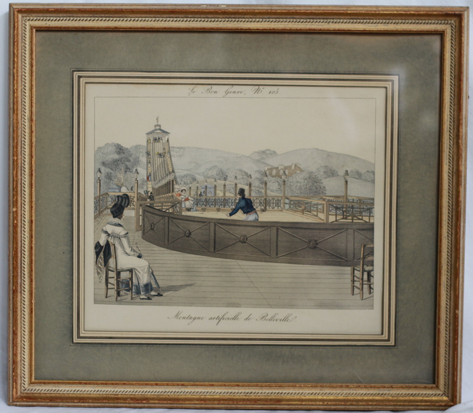 Le Bon Genre No. 105, Montagne Artificielle de Belleville: Early 19th-century French hand-colored etching depicting the Belleville amusement grounds in Paris. Framed and matted. Dimensions: H: 15.5 x W: 17.5 in.
