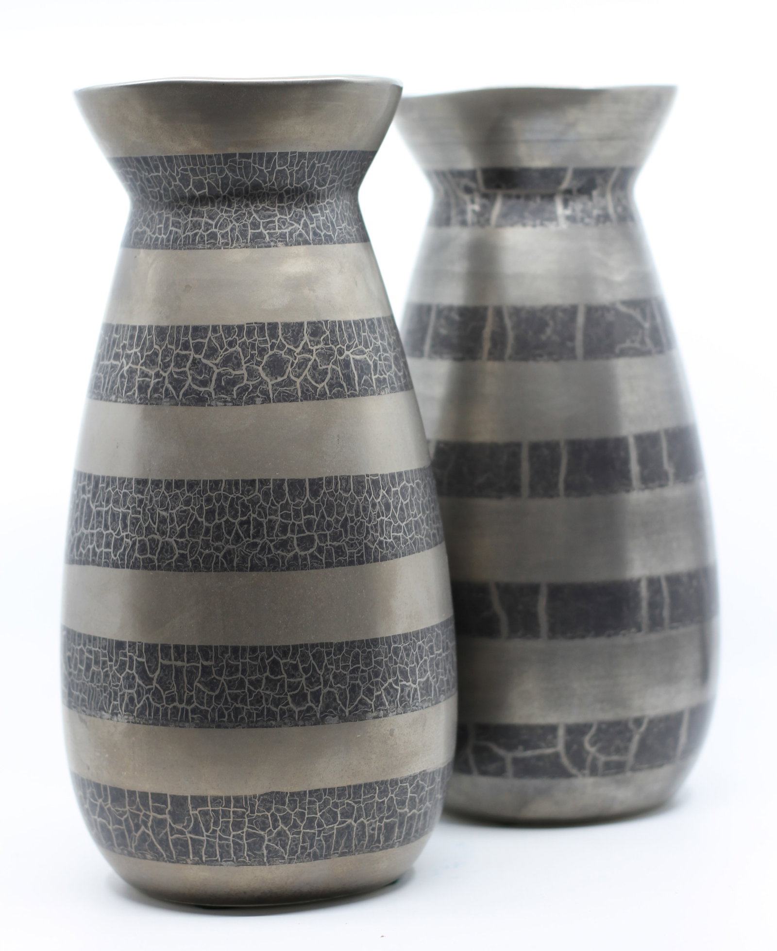 Pair of Mid-Century Modern Silver and Black Ceramic Vases: Pair of tapered ceramic vases with silver-tone finish and black crackle-pattern bands. Maker’s stamp to underside. Dimensions: H: 12 x W: 5.5 in.