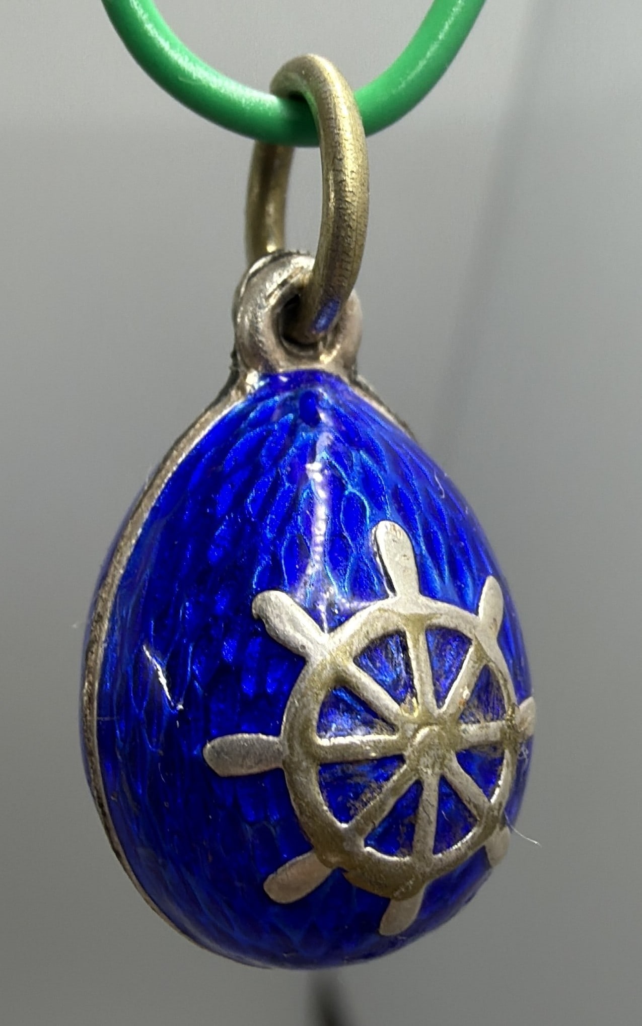 Russian 84 Silver Blue Enamel Nautical Egg Pendant: Egg-form pendant in vivid cobalt-blue guilloche-style enamel, applied with silver ship?s wheel and anchor motifs. Suspension ring bears an ?84? silver standard mark and Cyrillic maker?s mark.