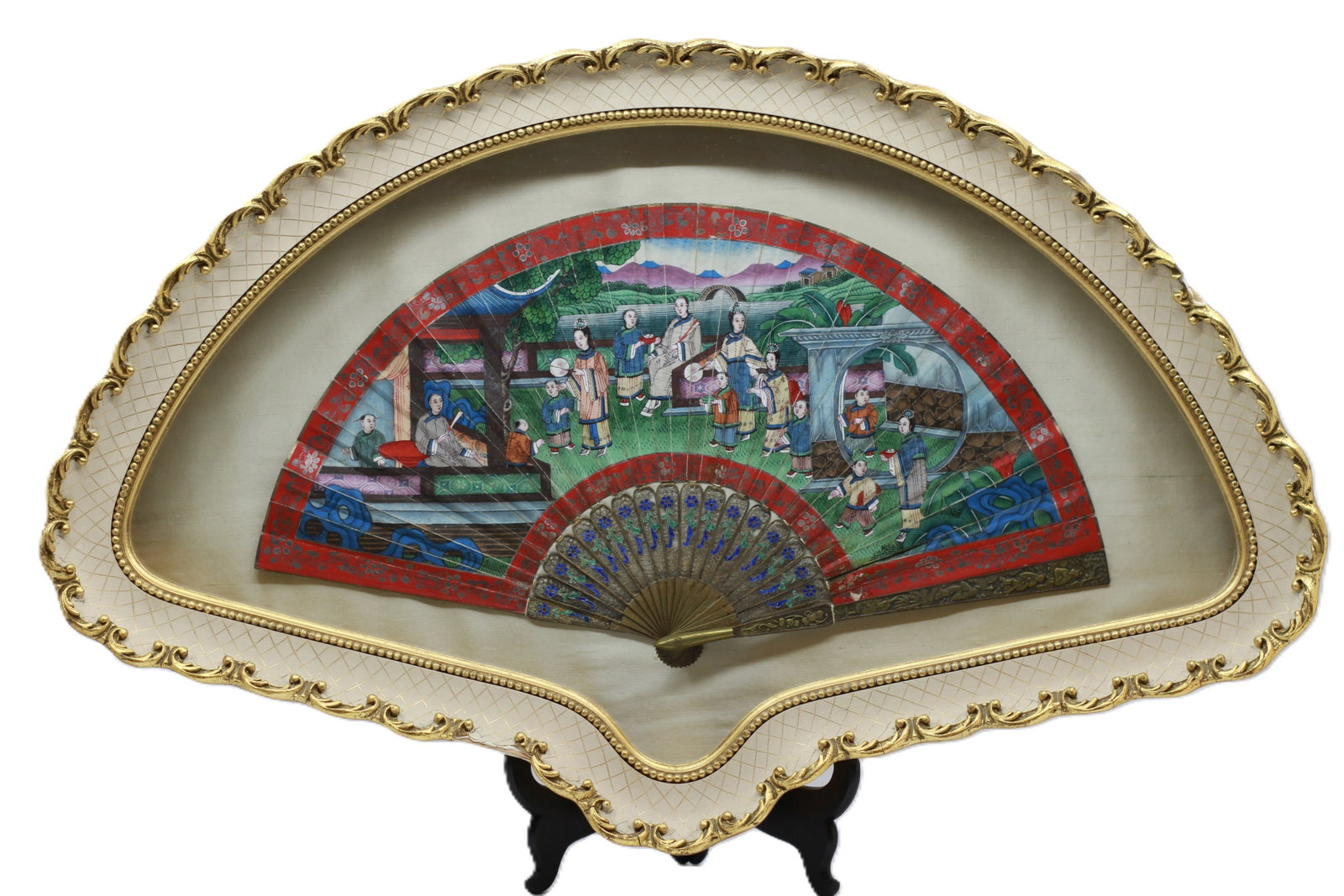 Chinese Folding Fan in Fan Shaped Frame: Fan features hand-painted scenes of figures in a courtyard garden, frame: 23 in x 15 in. actual fan 15 in x 8 in.