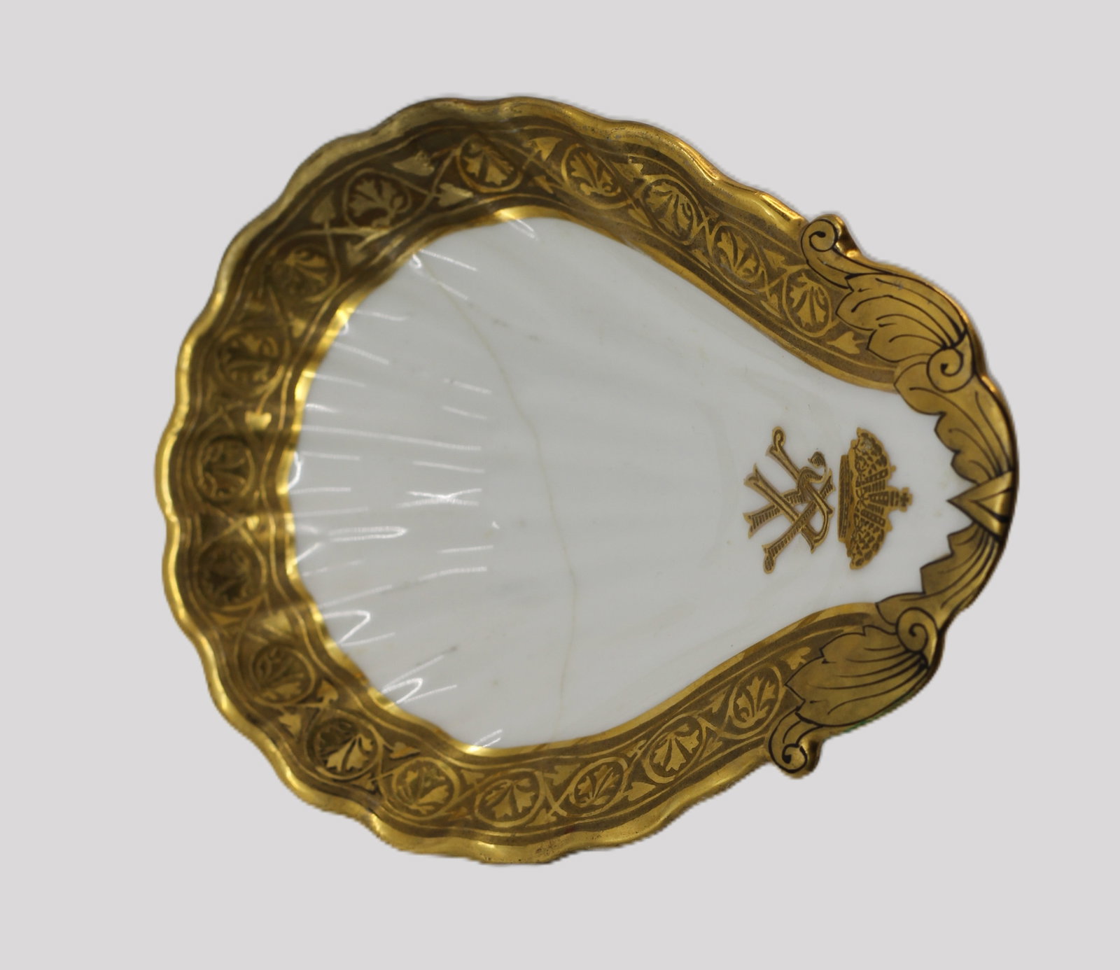 Imperial Russian-Style Gilt Porcelain Spoon Rest: Shaped white porcelain spoon rest or small serving dish with scalloped outline, richly decorated with broad gilt borders, engraved-style foliate ornament, an Imperial crown, and crossed ceremonial or 