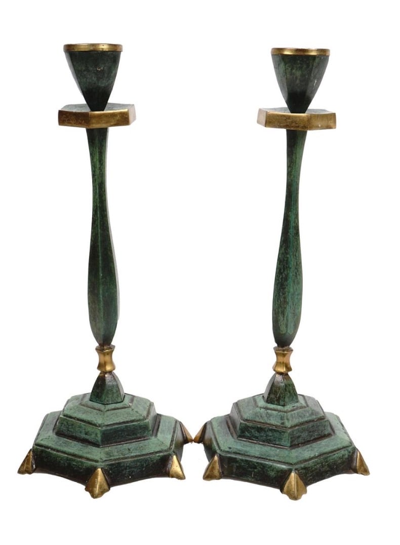 MID CENTURY ART DECO JUDAICA PAIR OF CANDLESTICKS: A pair of cast brass tall Art Deco Style candlestick holders. The surface is covered with a beautiful green patina. Mounted on hexagonal bases, marked on the bottom: Sabra, Made in Israel.
