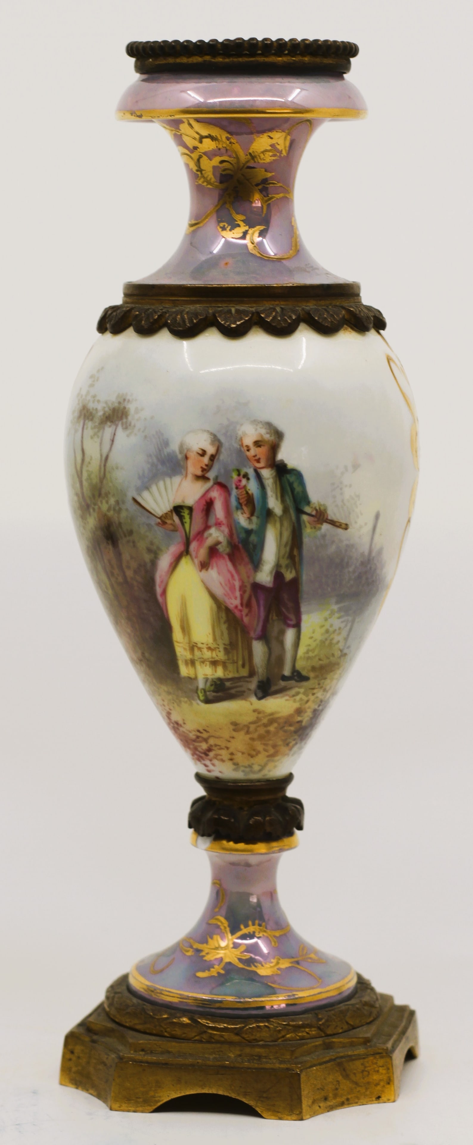 French Porcelain Bronze Mounted Scenic Vase: Antique French porcelain vase with bronze mounts and hand painted courting scene. Decorated with lavender iridescent glaze, gilt accents and landscape painting on reverse. Mounted on a gilt bronze bas