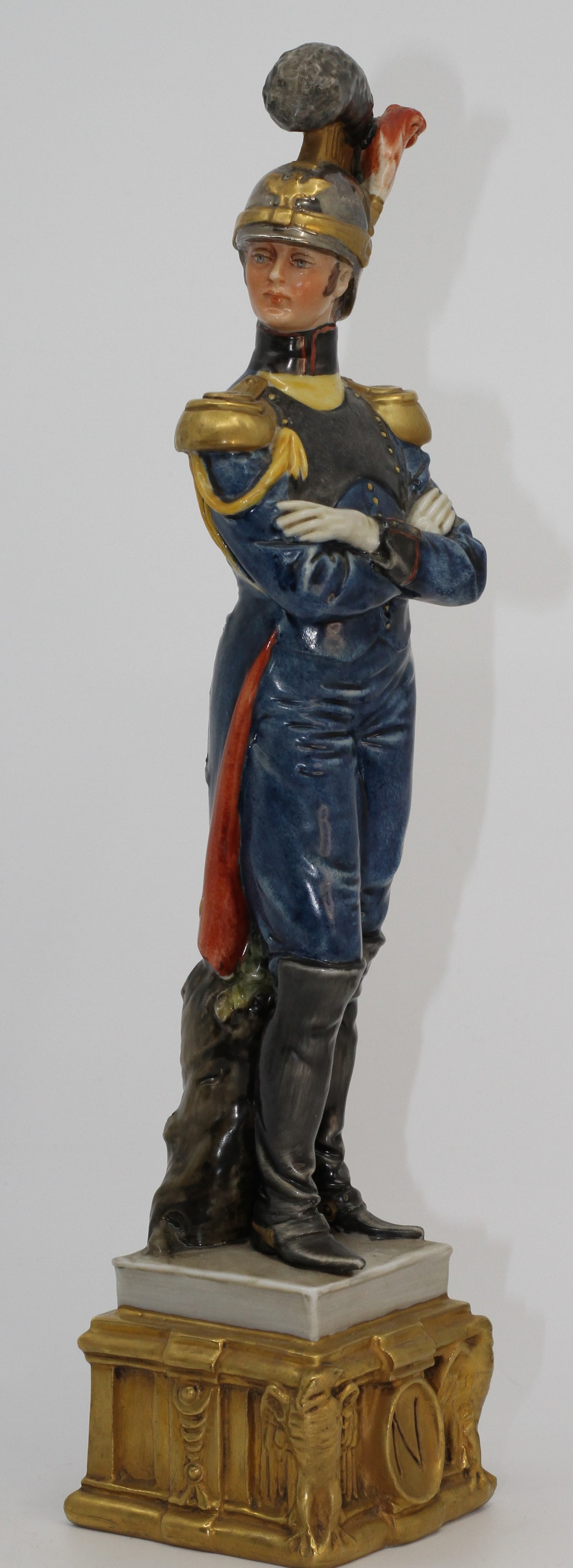 Capodimonte Bruno Merli Porcelain Military Officer Figurine: Large Capodimonte porcelain figure of a military officer in blue uniform with gilt details and plumed helmet. Signed Bruno Merli and marked Kings Porcelain to base.