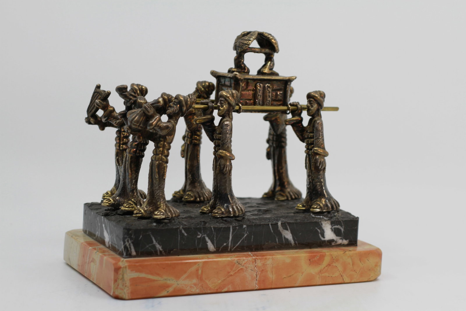 SILVER SCULPTURE ARK OF COVENANT BY JAMAL DAWANI: A sterling silver multi-figure composition representing people carrying the Ark of the Covenant, the most sacred relic of the Jewish. The sculpture is placed on a double marble base. An artwork by