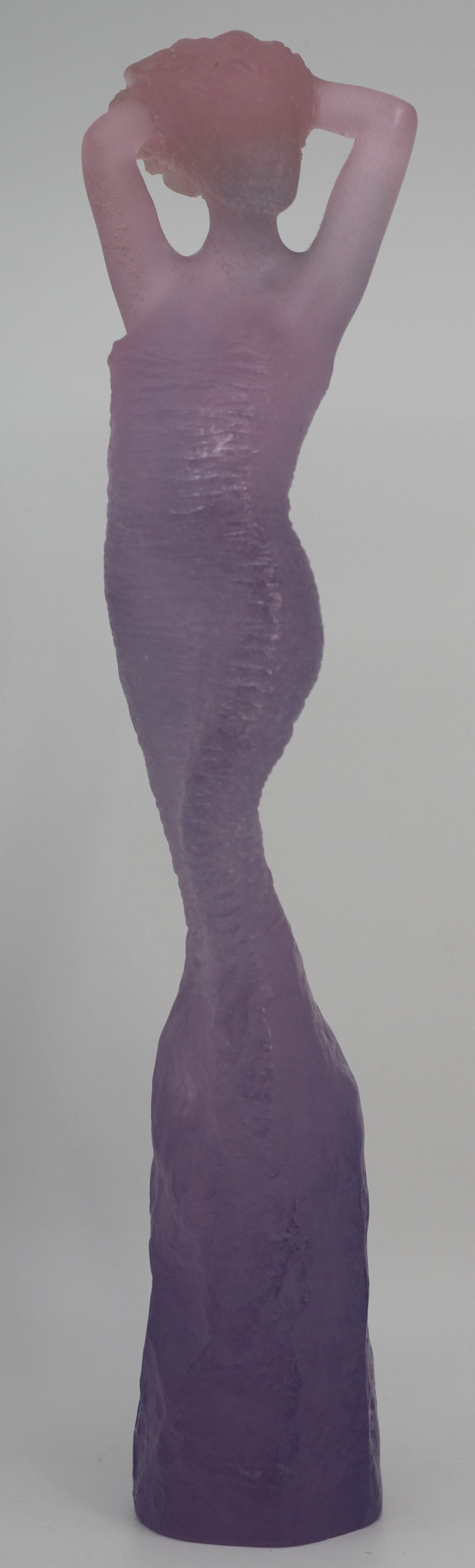 Daum France Pate de Verre Purple Female Figure Sculpture: Daum France pate de verre glass sculpture depicting a stylized standing female figure with raised arms. Graduated pink and purple coloration with textured surface and elongated form.