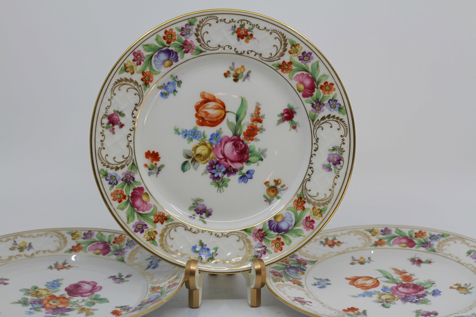 Set of Three Schumann Bavaria ?Dresden Flowers? Porcelain Dinner Plates: A set of three German porcelain dinner plates by Carl Schumann, Bavaria, decorated in the colorful Dresden Flowers pattern. Each plate features a central bouquet of roses, tulips, forget-me-nots and a