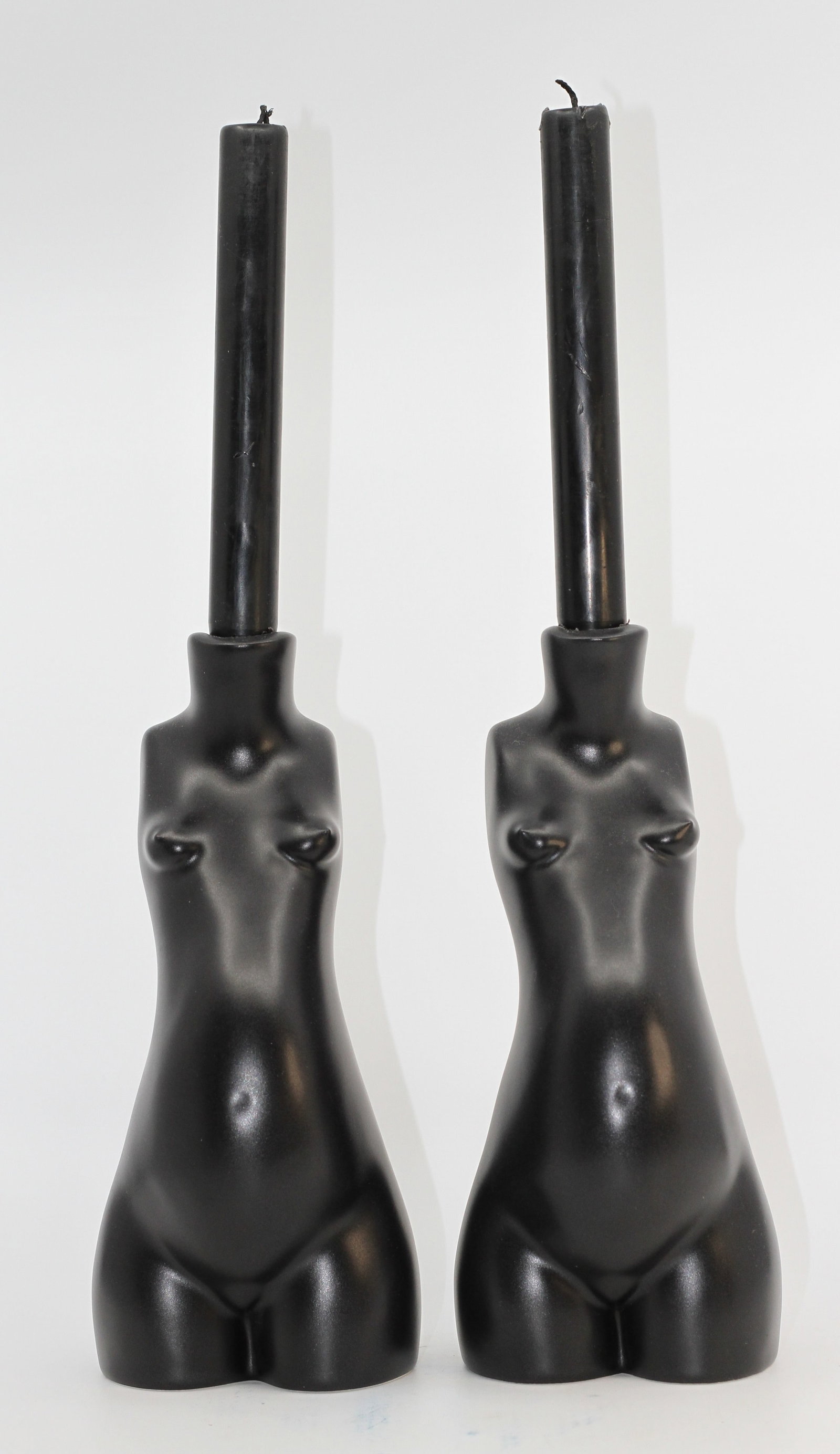 Pair Anissa Kermiche Tit For Tat Black Ceramic Candle Holders: Pair of Anissa Kermiche Tit For Tat ceramic candle holders in matte black, modeled as stylized female torsos. Each fitted to hold a taper candle. Marked on underside.