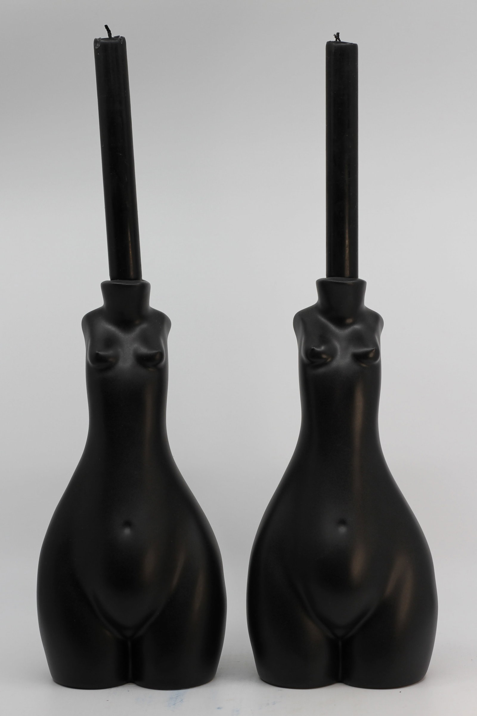 Pair Anissa Kermiche Tit For Tat Black Ceramic Candle Holders: Pair of Anissa Kermiche Tit For Tat ceramic candle holders in matte black, modeled as stylized female torsos. Each holds a taper candle. Retail label present on underside of one.