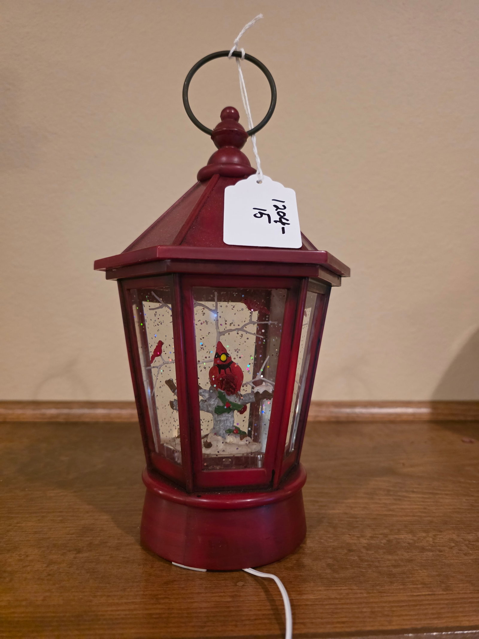 Red Bird musical snow globe: Red metal decor with music, lights and red bird all wrapped in one item. Everything works