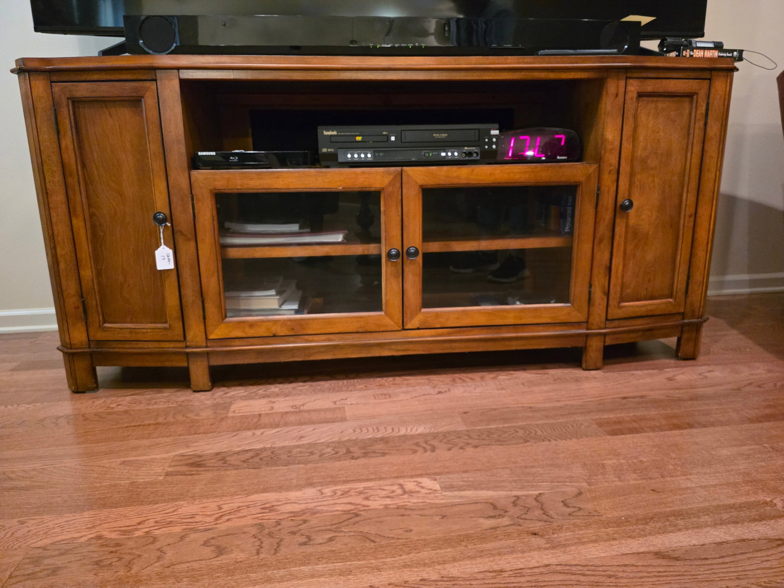 Large TV console: Solid wood and in great condition. It is a solid wood traditional American style cabinet. The glass center doors and open shelf are designed for DVD players, cable boxes or home theater equipment comm