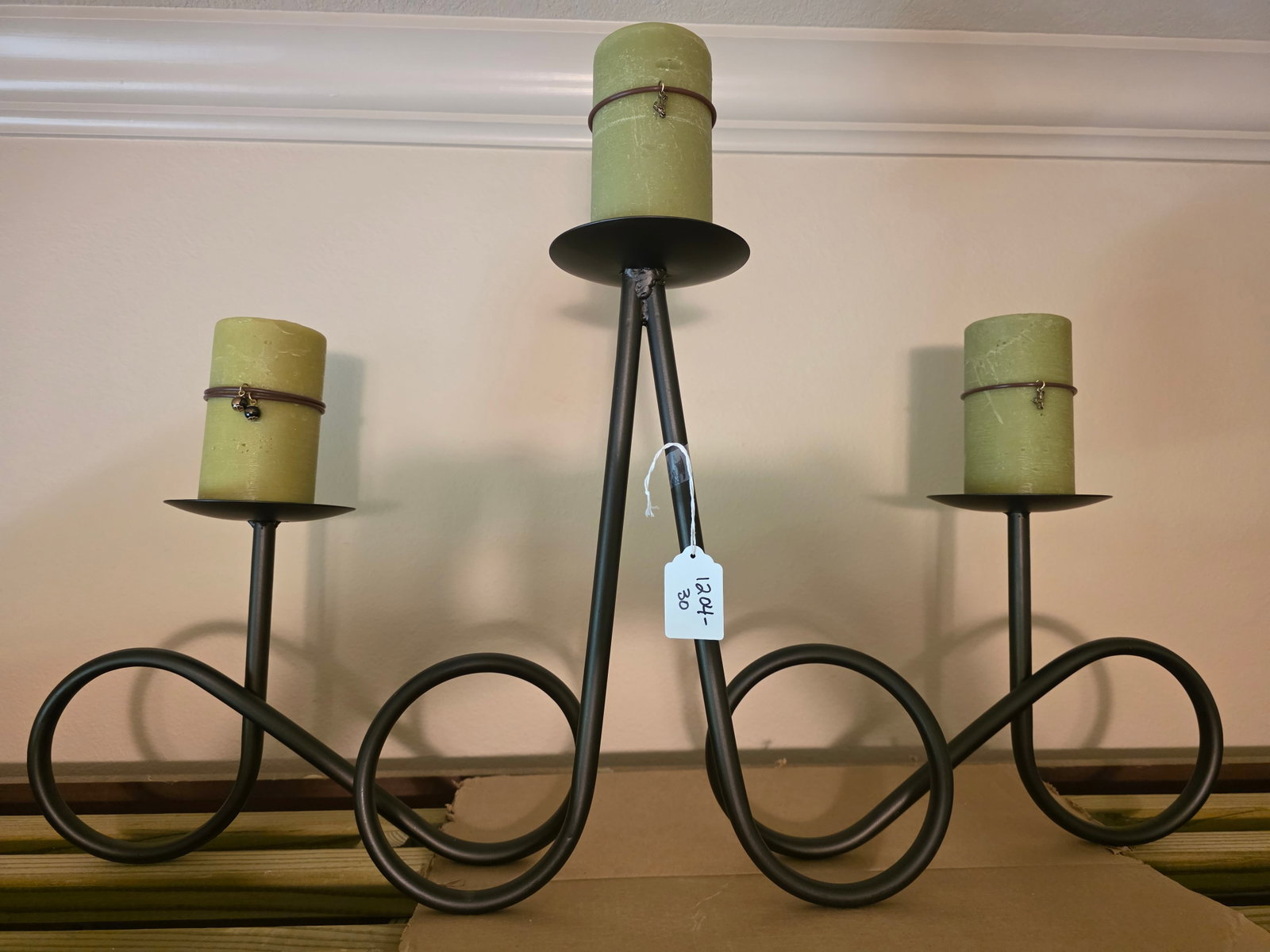 Large metal candlelabra: This piece is rather large. It is sitting on top of a hutch and spans most of the top of the hutch. Very nice metal work with the curves and bending as it is all one piece.