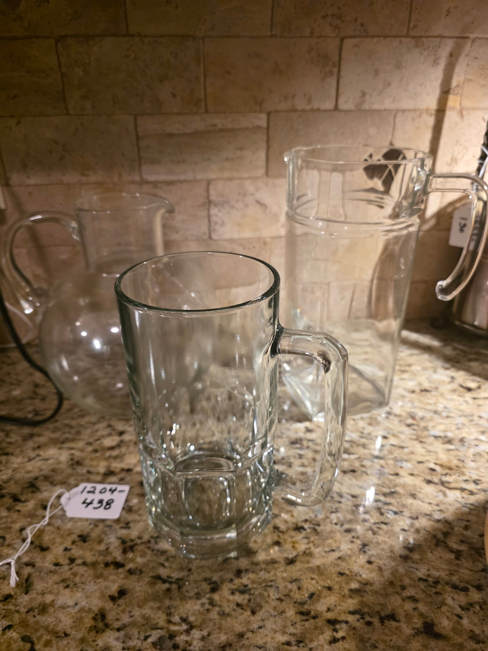 3 glass pitchers: large/tall clear glass pitchers and one beer mug very heavy
