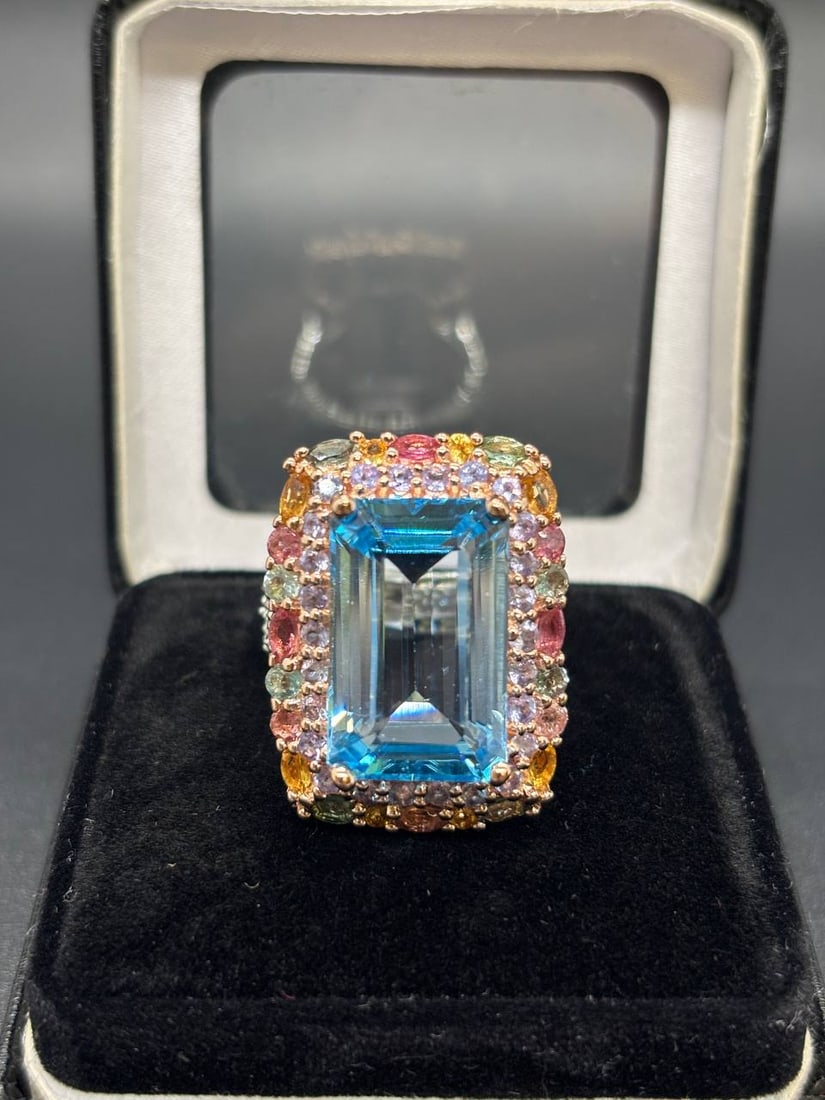 Bold Emerald Cut Blue Topaz Multi-Gem Ring: Striking and sophisticated — this custom handmade 925 sterling silver ring with 24KT gold plating delivers serious glamour through its layered halo design and vivid emerald-cut Blue Topaz