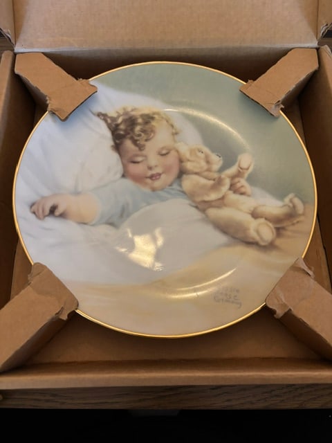 Bessie Pease Gutman, Happy Dreams, Plate # 0681C: Collectible Plate, 1987, Dinner plate of painting of toddler sleeping with a bear, Bundles of Joy Plate Collection, Second Issue,rim of plate is trimmed in 23K gold, distributed by The Heirloom Tradit