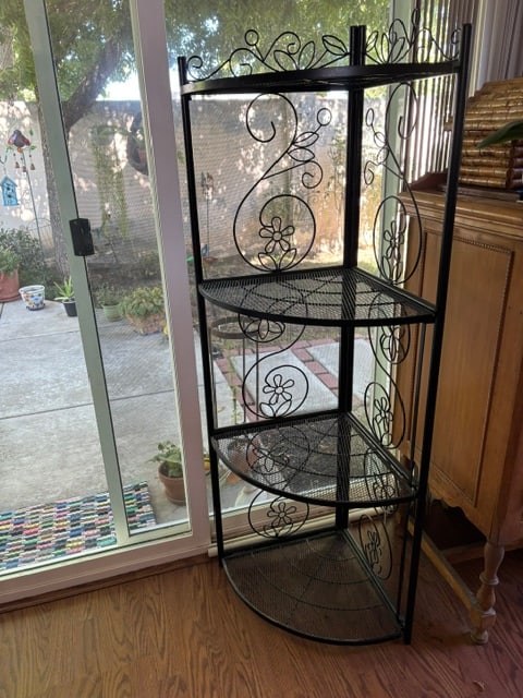Black Scrolled Accent Metal Foldable Corner Rack with Mesh Design Storage Shelves: This artistically designed corner rack is the ideal furniture piece to elegantly accomplish the vacant corners of your indoor or outdoor space. Durable metal construction with antique black finish pro