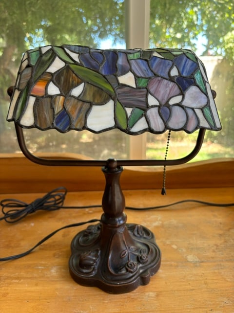 TIFFANY STYLE IRIS STAINED GLASS BANKER'S TABLE DESK LAMP: Vintage Tiffany-Style Floral Stained Glass Banker's Lamp. Piano style table lamp with pull chain switch. Floral stained glass pattern- colorful roses, tree root base, dark green foliage and olive hues