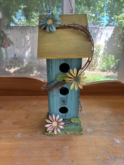 Distressed decorative birdhouse features a vibrant blue wood body and yellow metal flowers: Distressed decorative birdhouse features a vibrant blue wood body and yellow metal flowers3-tiered