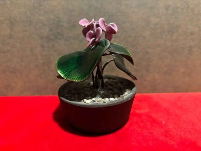 Petite Bovano of Cheshire Enamel Floral Decorative Planter Cyclamen Persicum: Bovano of Cheshire, circa 1960.A fine quality polychrome enamel decorated floral sculpture depicting Cyclamen Persicum.Dimensions: Height: 3.875 in (9.85 cm)Diameter: 3.5 in (8.89 cm)Style: American