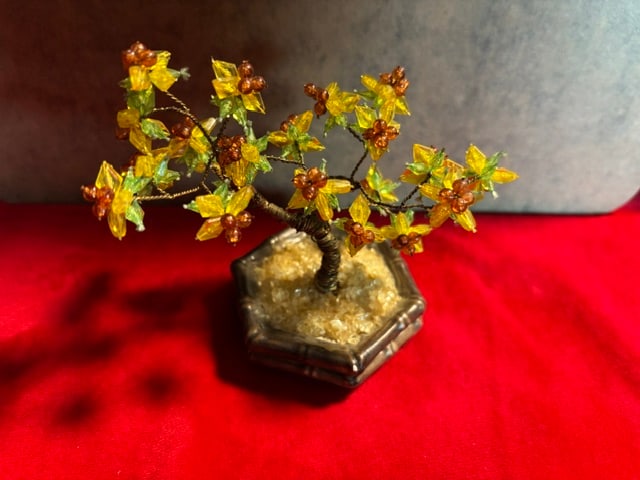 Bead Bonsai Tree: This yellow crystal gem tree is a feng shui money bonsai featuring a copper wire trunk and stone leaves for wealth and blessing.