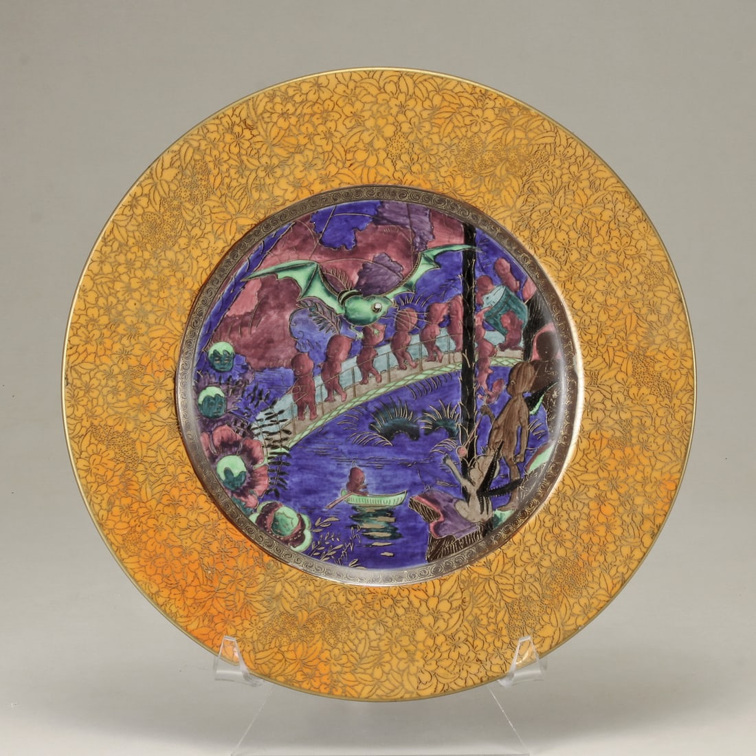 WEDGWOOD CA. 1924 REF: W558 FAIRYLAND LUSTRE PORCELAIN “IMPS ON A BRIDGE: DAISY MAKEIG-JONES, FOR WEDGWOOD CA. 1924 REF: W558 ENGLISH, 1881-1945 Wedgwood Fairyland Lustre Porcelain “Imps on a Bridge” (ROC Centre) Plate with orangy yellow Twyford