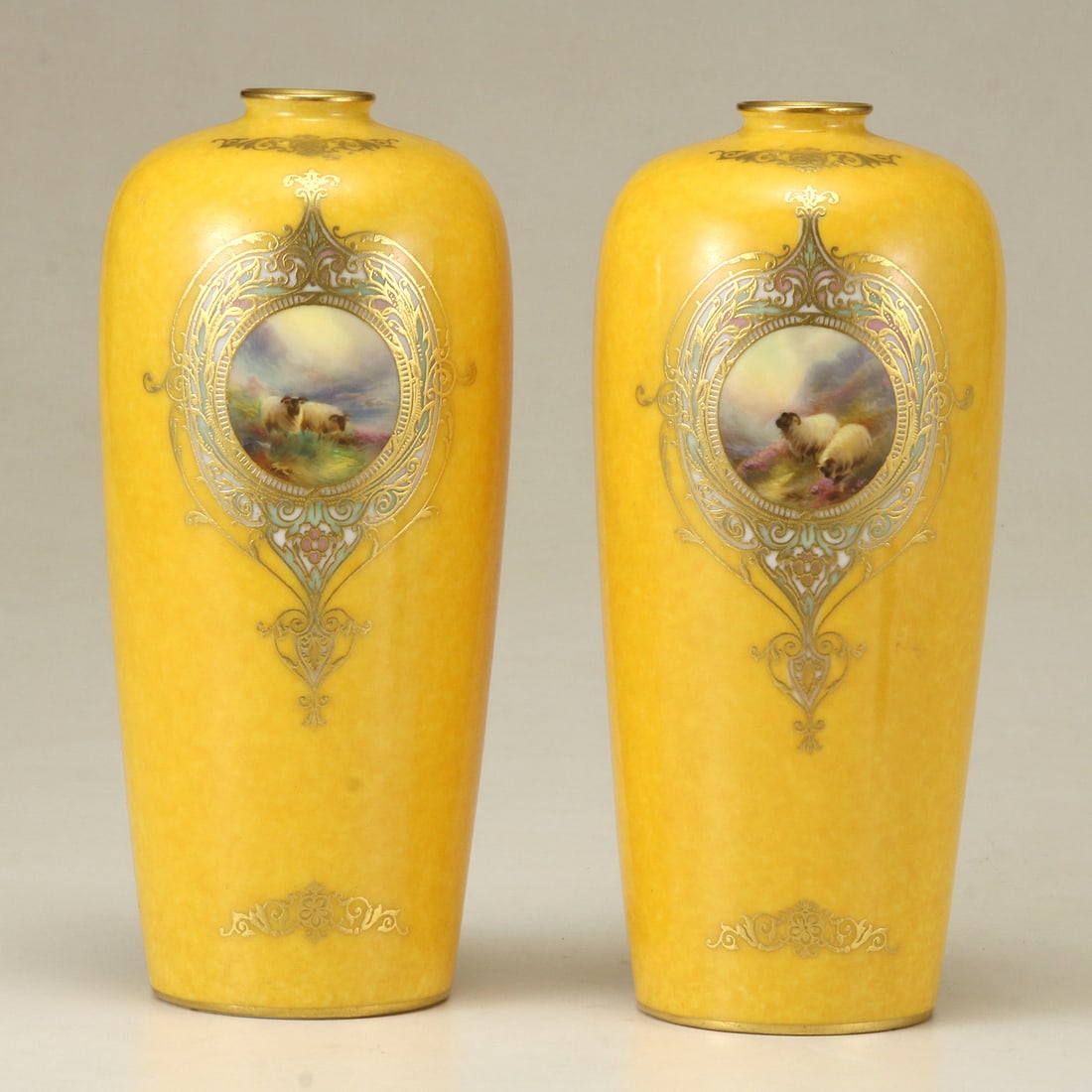 A PAIR OF HARRY DAVIS ROYAL WORCESTER MUSTARD YELLOW SHEEP VASES: A PAIR OF HARRY DAVIS ROYAL WORCESTER MUSTARD YELLOW, THINLY POTTED HAND PAINTED SHEEP/CATTLE VASES. Of slightly tapered ovoid form: depicting a reserve of highland sheep amongst a plush landsca