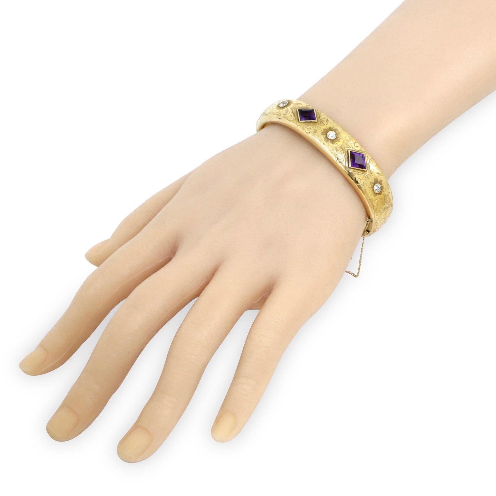 7.87CTTW CA. 1920 ART DECO 14KT YELLOW GOLD DIAMOND AND AMETHYST BANGLE BRACELET: 7.87CTTW CA. 1920 ART DECO 14KT YELLOW GOLD DIAMOND AND AMETHYST BANGLE BRACELET. The hand chased 15mm wide bangle set with 2 kite shaped bezel set amethyst, flanked by 3 Old European cut diamon
