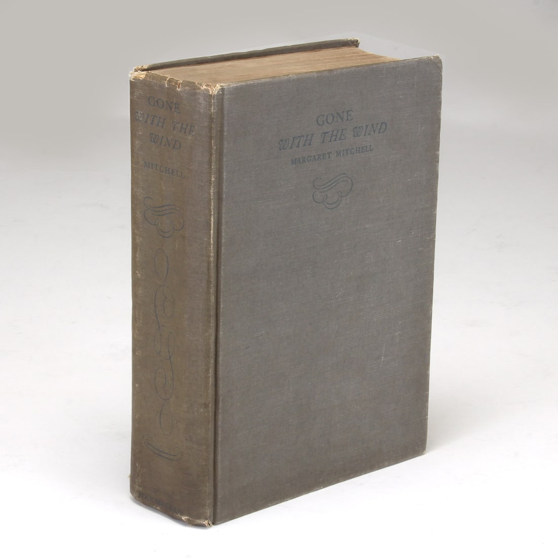 Gone with the Wind, Macmillan and Co., 1936. Margaret Mitchell: First edition: October 1936: Margaret Mitchell. Gone with the Wind. Toronto: Macmillan and Co., 1936. Octavo. [vi], 1037 Publisher's medium gray cloth, spine and front board lettered and decoratively stamped in dark blue, N