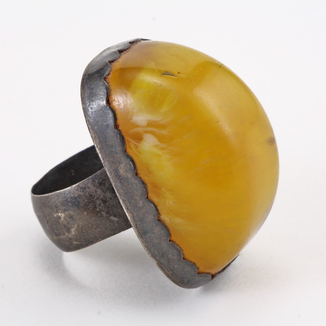 Ca. 1950 Baltic Butterscotch Amber Eggyolk Sterling Silver Ring: Ca. 1950 Baltic Butterscotch Amber Eggyolk Sterling Silver Ring. The Antique: ring of domed elongated form measuring 37.12 x 23.15 x 18.54mm - Of beautiful butterscotch yellow orange color with 