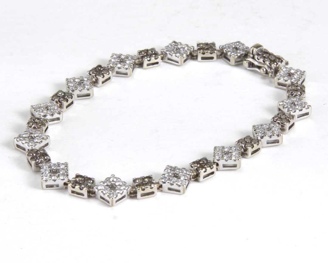 2.73CTTW MODERN 18KT WHITE GOLD & DIAMOND BRACELET: 2.73CTTW CA. 1980 MODERN 18KT WHITE GOLD & DIAMOND BRACELET. The dainty square/diagonal bracelet set with 182 round brilliant cut diamonds ranging in color from H-I to Cognac (Fancy Light Br