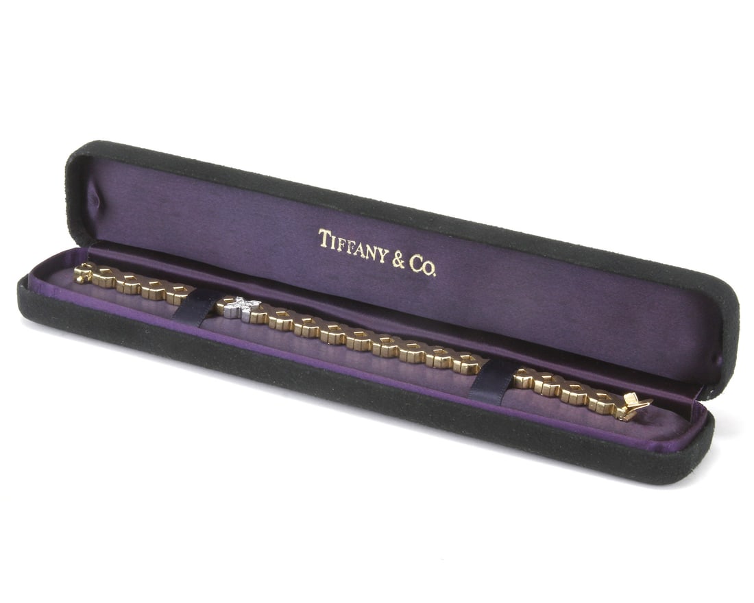 C1975 ANGELA CUMMINGS FOR TIFFANY & CO X BRACELET 8 DIAMONDS F-G VS: This vintage 18k two-toned gold diamond X bracelet is a masterpiece by Angela Cummings for Tiffany & Co as part of the 1975-1976 collection.