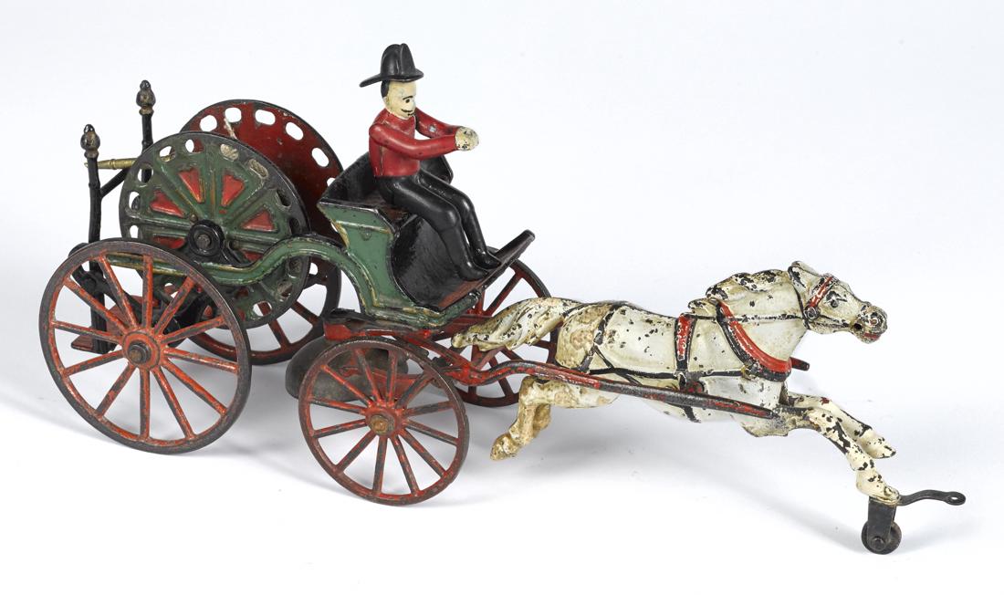Pratt & Letchworth cast iron horse drawn hose reel with: Pratt & Letchworth cast iron horse drawn hose reel with a painted driver, an ornate green and red hose reel, and a woven cotton hose with a brass nozzle, 15'' l.